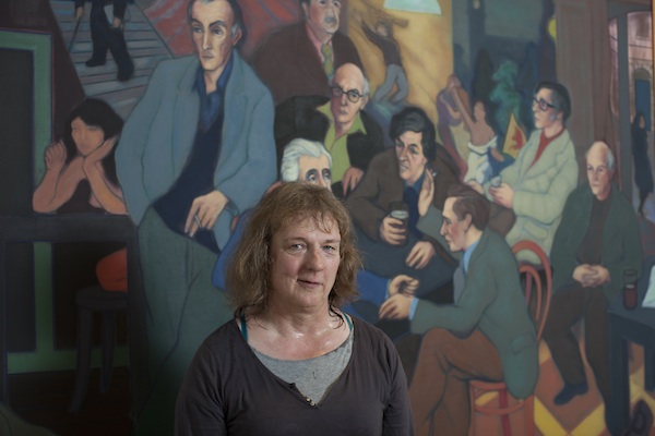 Jo Clifford in front of Aexander Moffat's Poets Pub. She wrote a monologue for the unnamed women to the left of the painting. Photo © Peter Dibdin